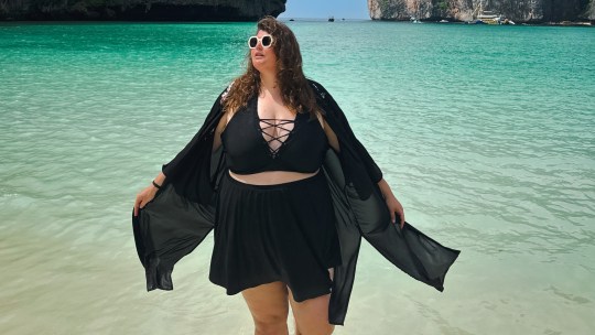 Plus size travel creator Beck of Manfattan posing outdoors